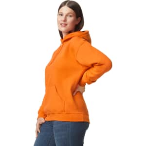 A woman is wearing an orange Gildan DryBlend adult hooded sweatshirt, featuring a front pocket and a hood.