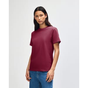 A maroon heavyweight cotton unisex T-shirt displayed on a model, featuring a logo on the collar.