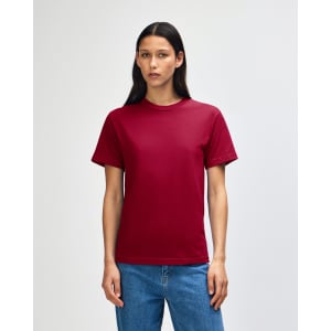 A unisex heavyweight cotton t-shirt in a deep burgundy colour, displayed on a model with straight black hair.
