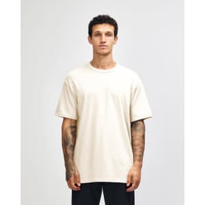 A heavyweight cotton unisex T-shirt in a light cream colour, featuring a standard crew neck and short sleeves.