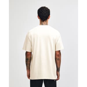 A cream heavyweight cotton unisex T-shirt displayed on a model, featuring short sleeves and a plain back.