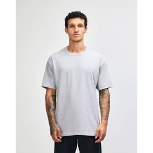 A heavyweight cotton unisex T-shirt in grey, featuring short sleeves and a relaxed fit. It has a logo on it.