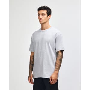 A heavyweight cotton unisex T-shirt in light grey, featuring a relaxed fit and short sleeves. It has a logo.