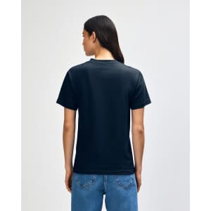 A black heavyweight cotton unisex T-shirt viewed from the back, worn with blue jeans. The shirt features a logo.