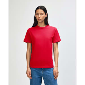 A red heavyweight cotton unisex t-shirt displayed on a model with curly hair, featuring a simple design.