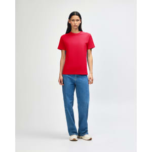 A red heavyweight cotton unisex T-shirt displayed on a model, paired with blue cargo pants.