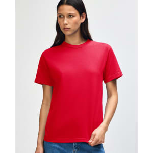 A red heavyweight cotton unisex T-shirt displayed on a model with curly hair. The shirt has a logo on it.