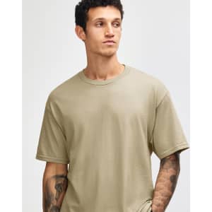 A heavyweight cotton unisex t-shirt in khaki, featuring short sleeves and a relaxed fit. It has a logo.