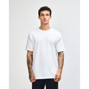 A lightweight unisex t-shirt in white, featuring a round neck and short sleeves, displayed on a model.