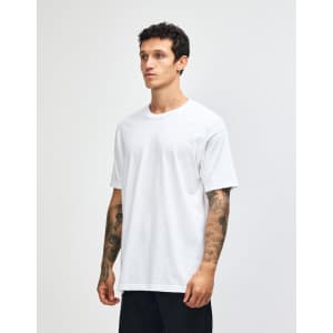 A heavyweight cotton unisex T-shirt in light grey, displayed on a male model. The shirt features a logo.