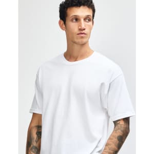 A heavyweight unisex t-shirt in light grey, featuring a classic crew neckline and short sleeves. It has a logo on it.