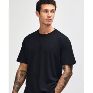 A unisex heavyweight cotton t-shirt in black, featuring a relaxed fit and a brand logo.