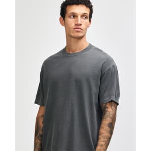 A grey unisex garment-dyed heavyweight cotton T-shirt with a relaxed fit and short sleeves, featuring a logo.
