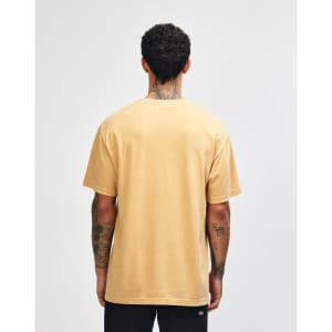 A unisex garment dyed heavyweight cotton t-shirt in a warm beige colour, viewed from the back. Features a logo.