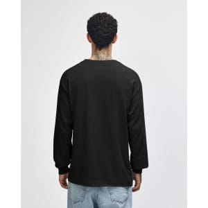 A black heavyweight cotton unisex long sleeve t-shirt viewed from the back, worn with olive green pants.