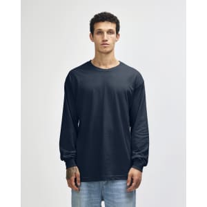 A navy unisex long sleeve T-shirt made from heavyweight cotton, displayed on a model against a plain background.