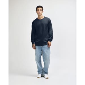 A model wearing a navy long sleeve T-shirt and light blue jeans, standing against a plain background.