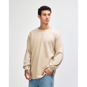 A beige heavyweight cotton unisex long sleeve T-shirt, featuring a rounded neckline and long sleeves.