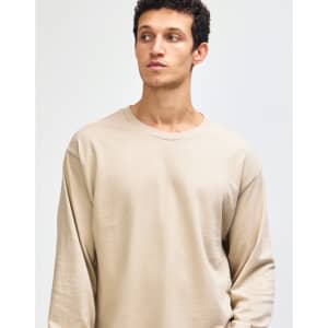 A beige heavyweight cotton unisex long sleeve t-shirt, featuring a round neckline and a plain style.
