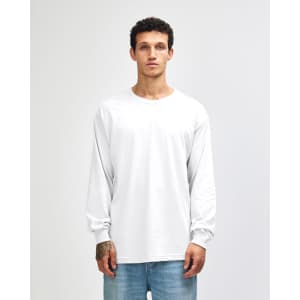 A heavyweight cotton unisex long sleeve T-shirt in white, displayed on a model with straight black hair.