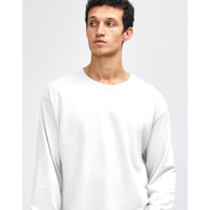A heavyweight cotton unisex long sleeve T-shirt in white, featuring a minimalistic design and a logo.