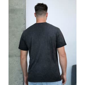 A dark charcoal grey t-shirt with a simple design, shown from the back on a model against a plain background.