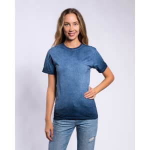 A woman poses in a navy blue Colortone® oil wash T-shirt, paired with denim jeans. The shirt has a soft, textured look and has a logo.