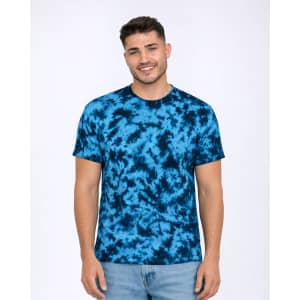 A tie-dye T-shirt in shades of blue, featuring a round neckline and short sleeves. The model is standing and smiling.