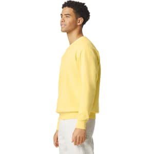 A lightweight crewneck sweatshirt in yellow, featuring a relaxed fit and long sleeves, with a logo on the front.
