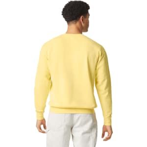 A lightweight crewneck sweatshirt in soft yellow, featuring a simple design and a logo on the back.