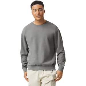 A lightweight crewneck sweatshirt in grey, worn by a model. Features ribbed cuffs and a logo.