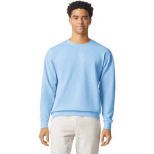 A lightweight crewneck sweatshirt in light blue, featuring a plain design and a logo on the front.