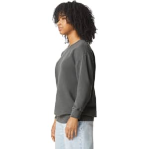 A grey sweatshirt featuring a crewneck design, shown from the side with a relaxed fit and long sleeves.