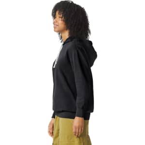 A lightweight hooded sweatshirt in black, featuring a logo, displayed on a model from the side.