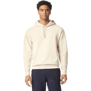 A lightweight hooded sweatshirt in beige, featuring a simple design and a logo on the front.