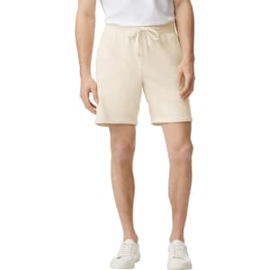 Lightweight sweatshorts in a cream colour with an elastic waistband and drawstring detail, featuring a logo.