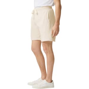 Lightweight sweatshorts in a light beige colour, featuring a drawstring waist and side pockets.