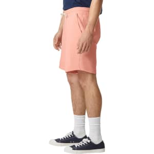 Lightweight sweatshorts in a coral colour, featuring an elastic waistband and side pockets, displayed on a model.