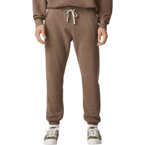 Brown lightweight sweatpants with a drawstring waist, featuring a logo, paired with casual shoes.