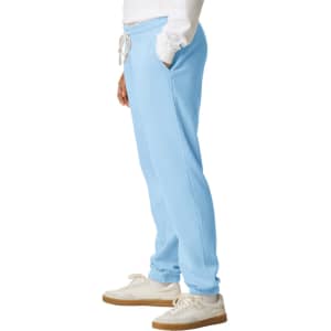 Light blue lightweight sweatpants with an elastic waistband and side pockets, paired with white sneakers.