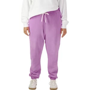Lightweight sweatpants in a pastel purple colour, featuring an elastic waistband and cuffs, with a logo on the garment.