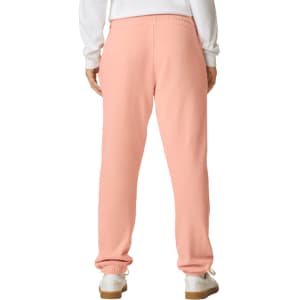 Lightweight sweatpants in peach, featuring an elastic waistband and a logo on the back.