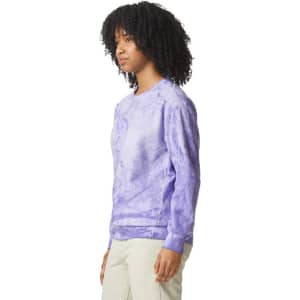 A purple tie-dye crewneck sweatshirt with long sleeves and a logo on the front.