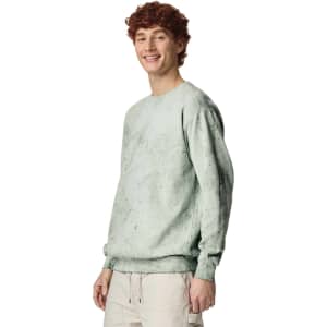 A mint green crewneck sweatshirt with a relaxed fit and long sleeves, featuring a logo on the front.