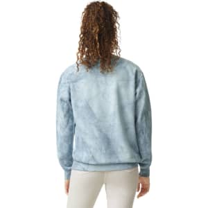 A crewneck sweatshirt in a blue marble pattern, featuring a logo and a relaxed fit.