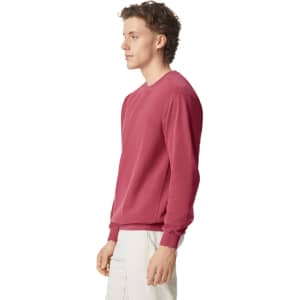 A maroon adult crewneck sweatshirt displayed on a model from the side, featuring long sleeves and a fitted design.
