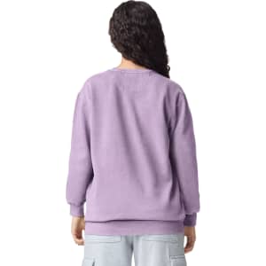 A lilac adult crewneck sweatshirt with a relaxed fit and long sleeves, featuring a logo on the back.