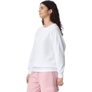 A white adult crewneck sweatshirt featuring long sleeves, displayed on a model with curly hair.
