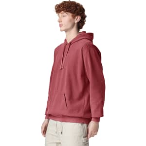 A maroon adult hooded sweatshirt with a front pocket and a drawstring hood, featuring a logo.