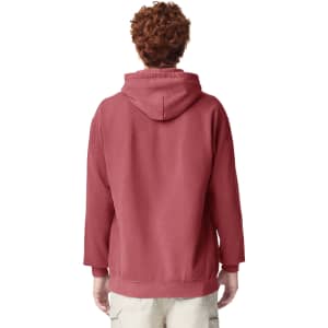 A hooded sweatshirt in a deep red colour, featuring a back view of a person wearing it. The design includes a logo.